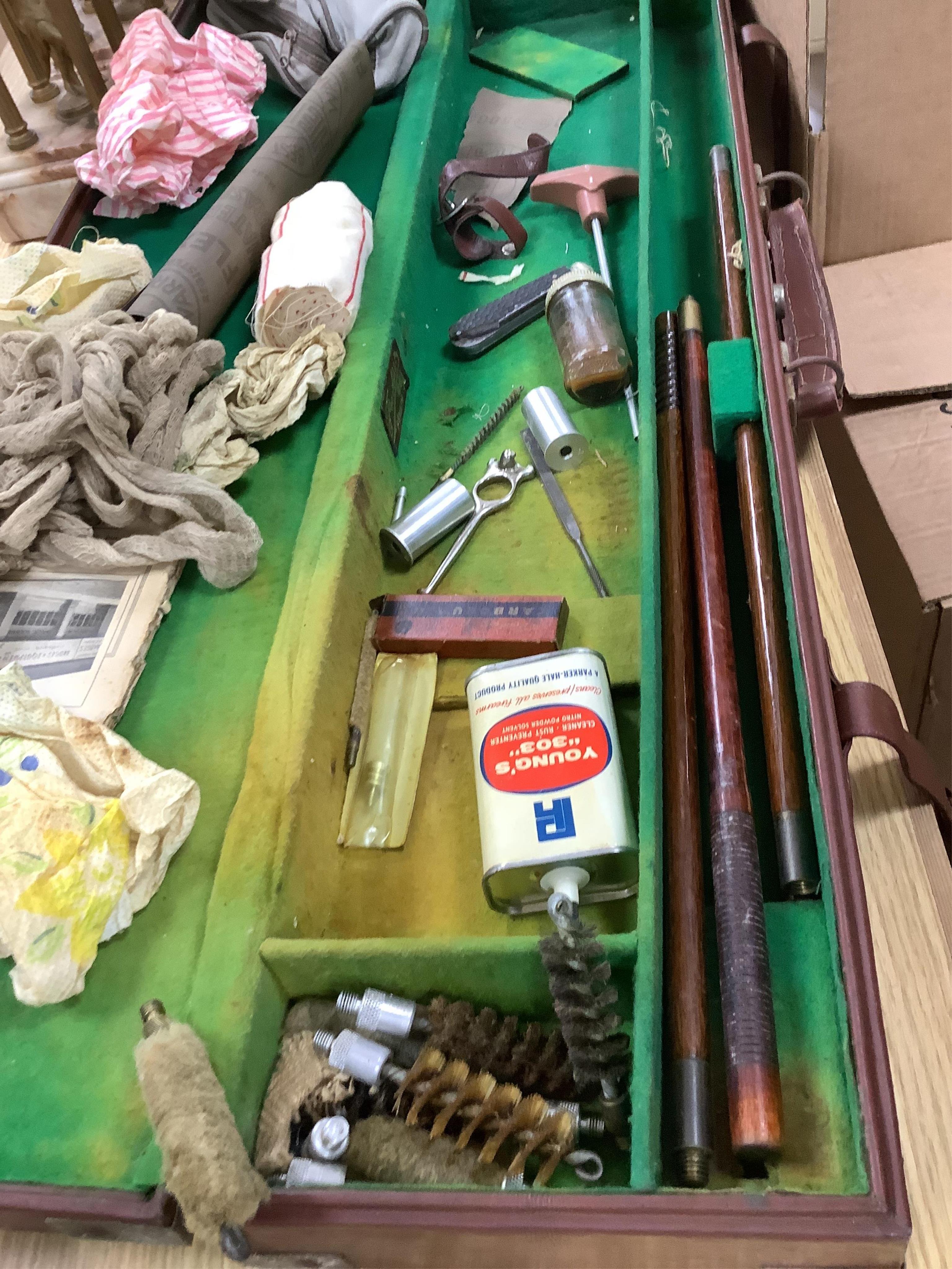 A gun case, various gun cleaning equipment and a brown leather suitcase. Condition - fair